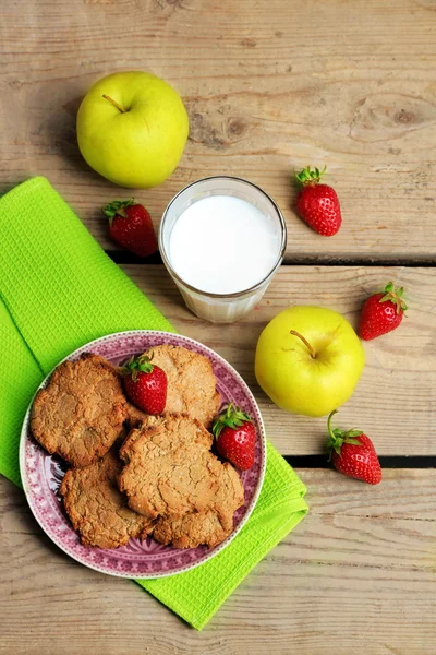 Homemade cookies with fruits and glass of milk on table close up — Stock Photo, Image