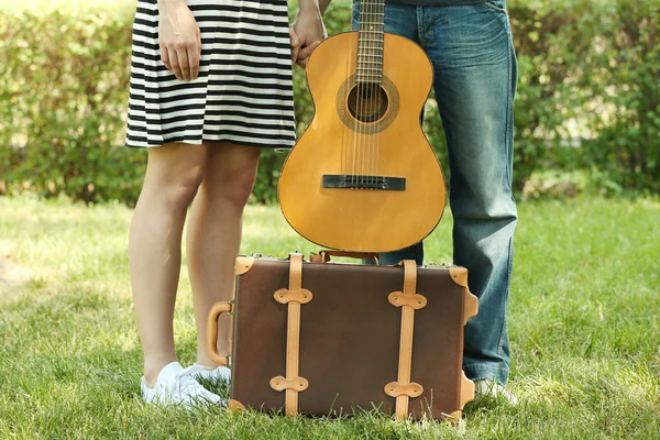 Pareja joven con maleta y guitarra — Foto de Stock