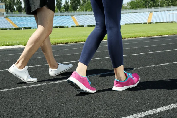 Young people jogging on stadium — Stock Photo, Image