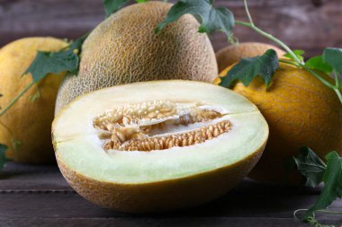 Ahşap masa üzerinde yeşil yaprakları ile olgun karpuz yakın çekim