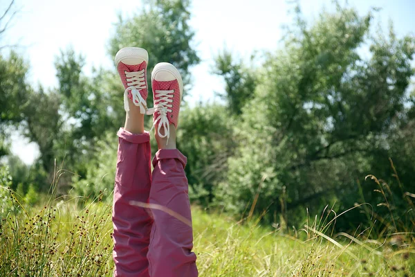 Female legs in colorful sneakers — Stock Photo, Image