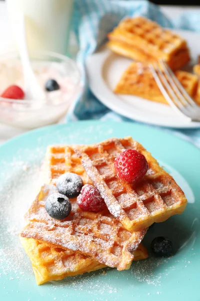 Sweet homemade waffles with forest berries on plate, on light background — Stock Photo, Image