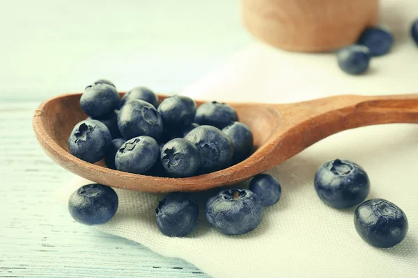 Fresh blueberries in spoon on wooden table close up — Stock Photo, Image