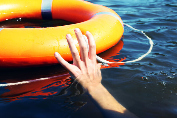 Hand trying to hold life buoy