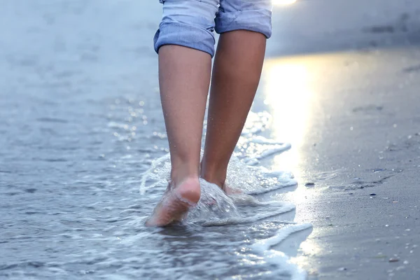 Vrouw die op het strand loopt — Stockfoto