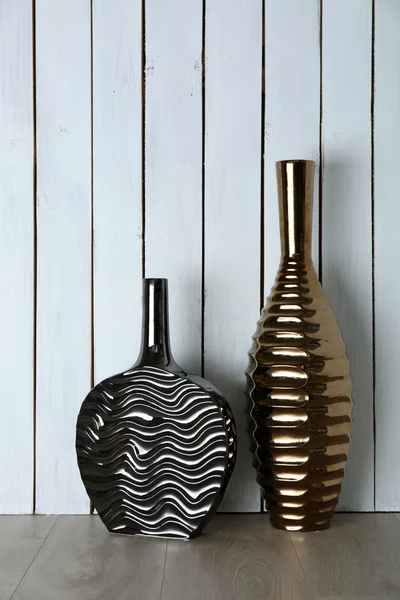 Beautiful vases on wooden wall — Stock Photo, Image