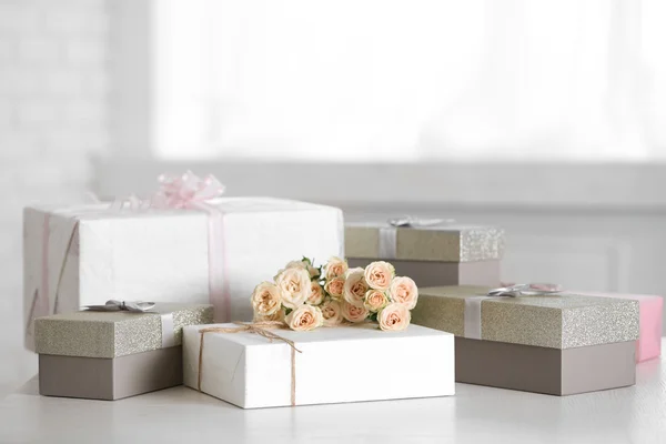 Decorated gift boxes and bouquet of roses — Stock Photo, Image