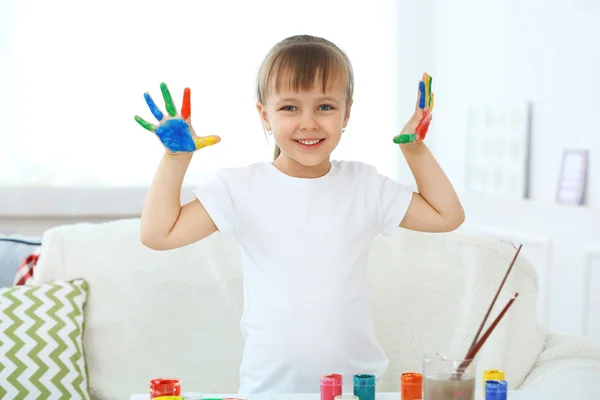 Little girl with hands in paint — Stock Photo, Image