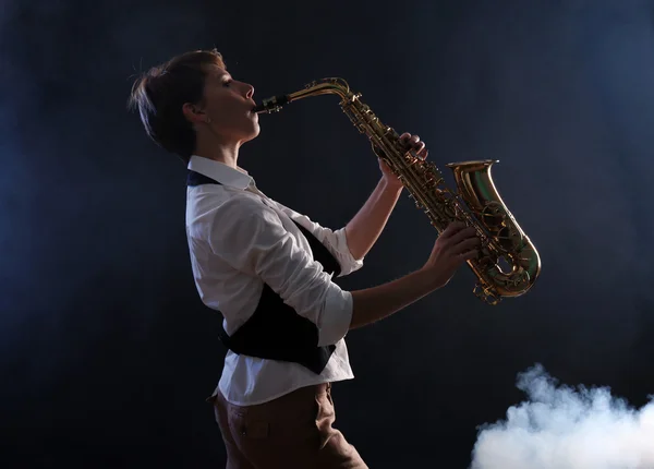 Привлекательная женщина играет на саксофоне — стоковое фото