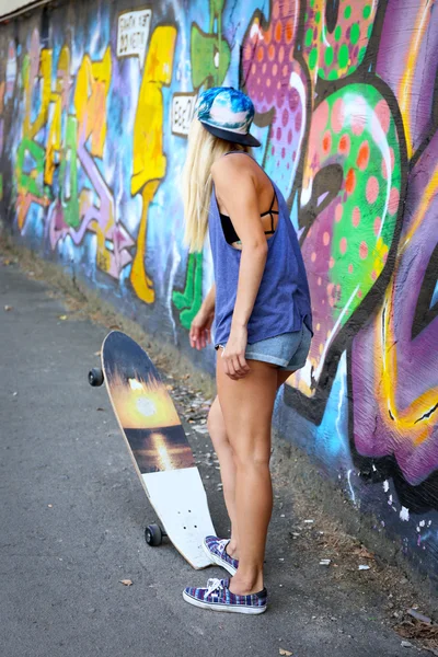 Woman with skating board — Stock Photo, Image