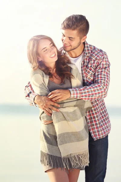 Young couple on the riverside — Stock Photo, Image
