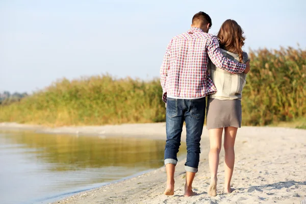 Pareja joven en la orilla del río —  Fotos de Stock