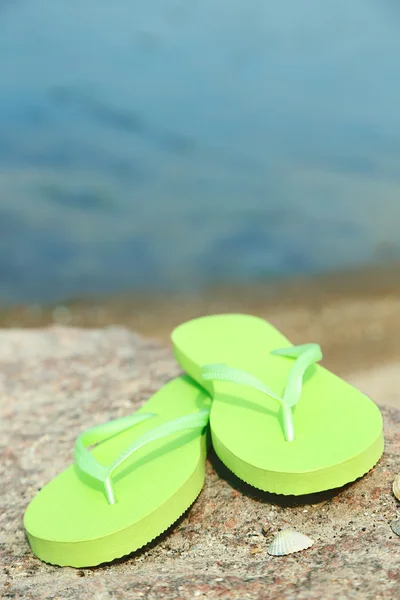 Bright flip-flops on stone — Stock Photo, Image