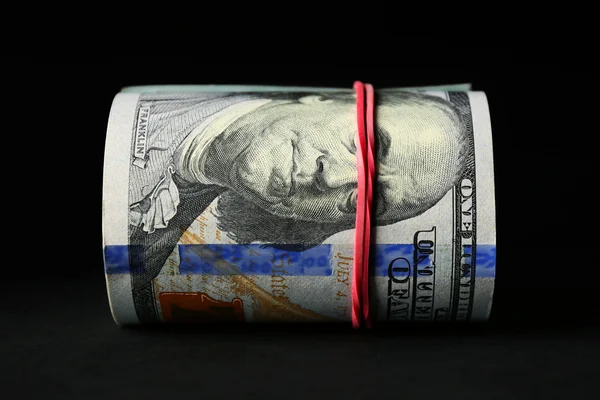 Доллары на черном фоне — стоковое фото