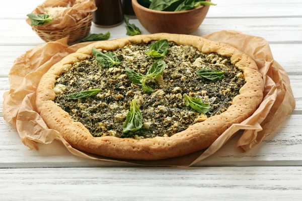 Open pie with spinach on table close up — Stock Photo, Image
