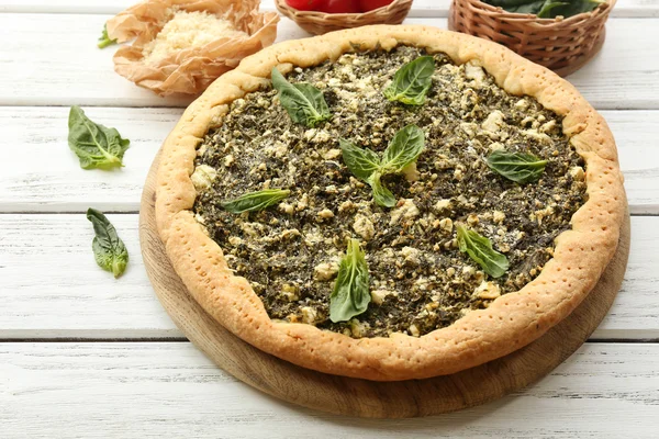 Open pie with spinach on table close up — Stock Photo, Image