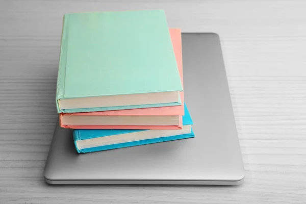 Stack of books with laptop — Stock Photo, Image