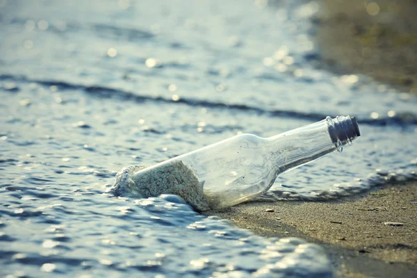 Glass bottle with sand — Stock Photo, Image