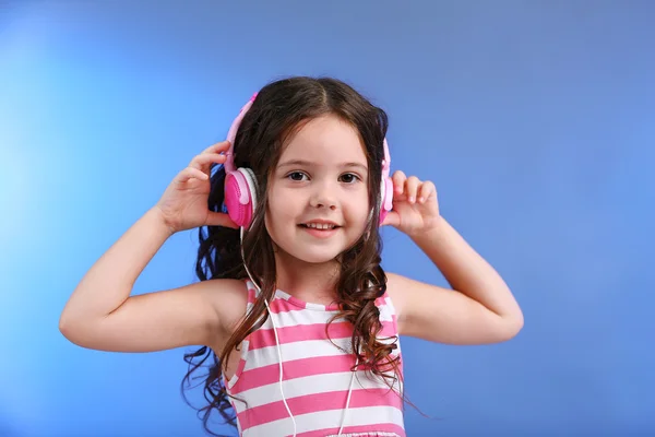 Attractive little girl with pink headphones — Stock Photo, Image