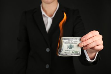 Woman burning dollars   clipart