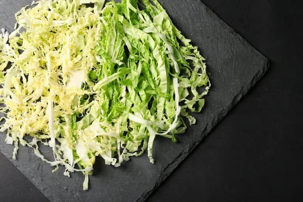 Cut savoy cabbage on dark grey background — Stock Photo, Image