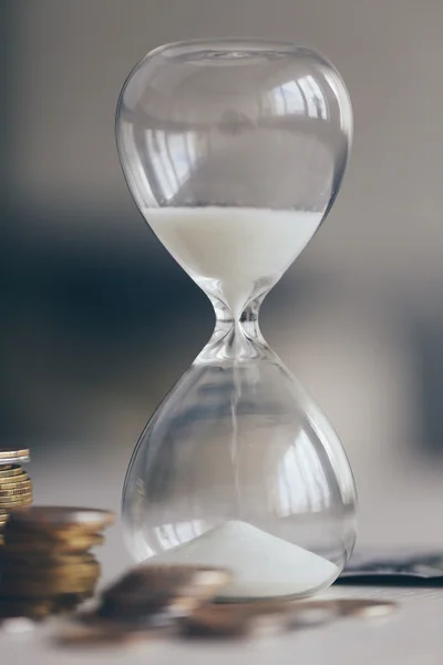 Antique Hourglass with coins — Stock Photo, Image