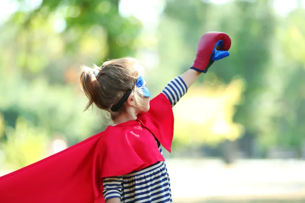 little girl dressed as superhero