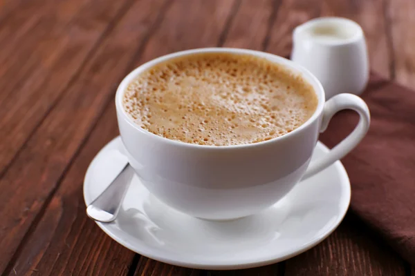 Cup of coffee on napkin — Stock Photo, Image