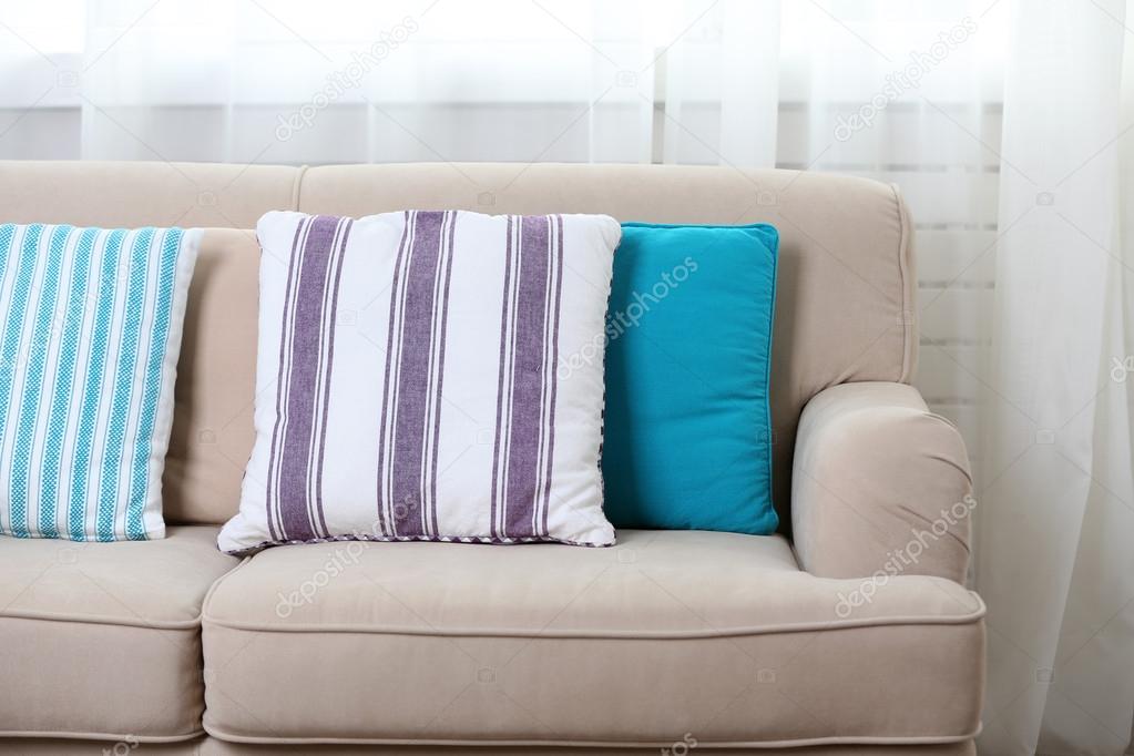 Comfortable sofa with colourful pillows  