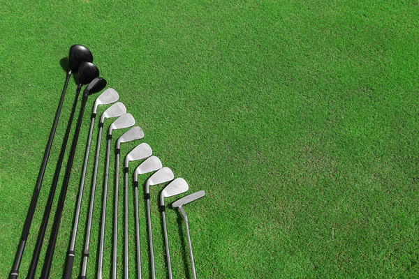 Different golf clubs in a row — Stock Photo, Image