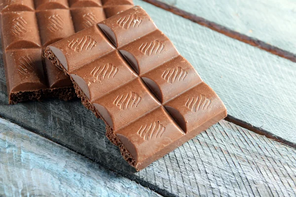 Chocolate on wooden background — Stock Photo, Image