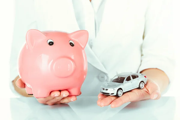 Woman with model of car and piggy bank — Stock Photo, Image