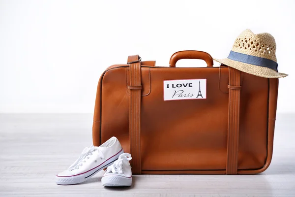 Suitcase with stickers on floor — Stock Photo, Image