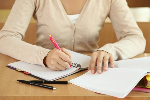 Female hand writing in notebook — Stock Photo, Image