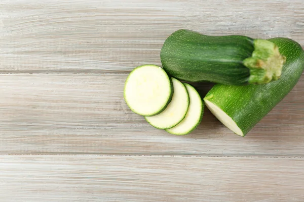 Fresh zucchini on wooden background — Stock Photo, Image