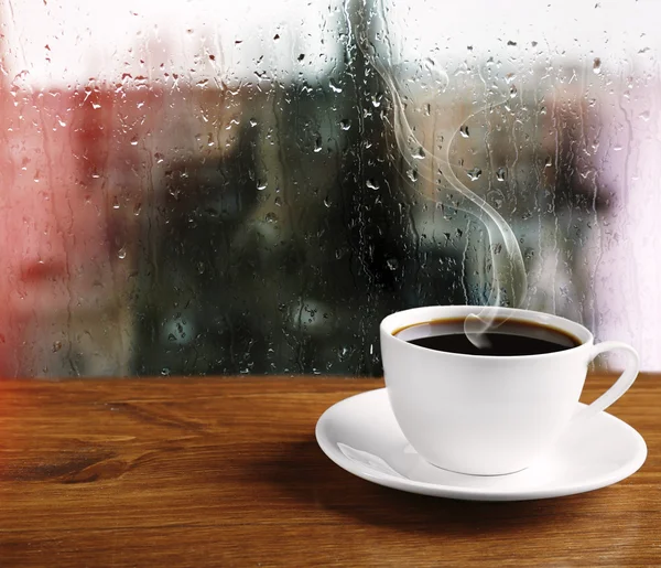 Cup of coffee on window background — Stock Photo, Image