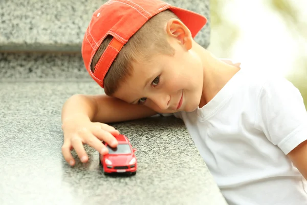 Boy playing with toy car — Stock Photo, Image