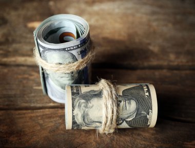 Dolar ahşap arka plan üzerinde rulo
