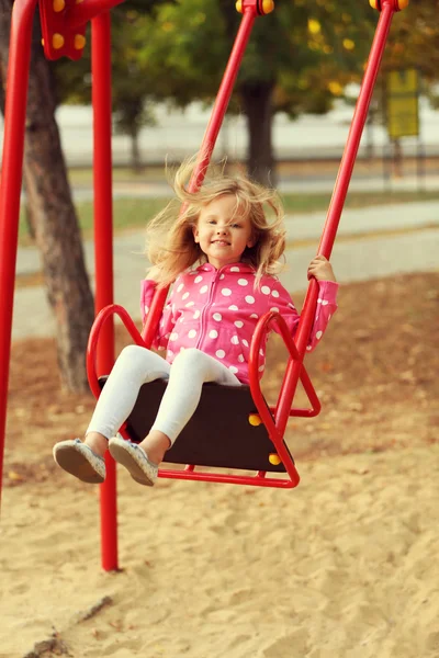 Little girl having fun on swing — Stock Photo, Image