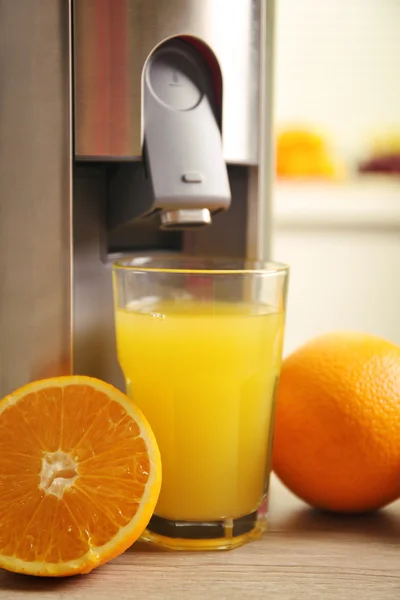 Sokowirówka i soku pomarańczowego na stole w kuchni — Zdjęcie stockowe
