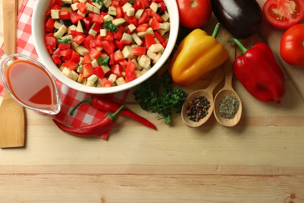 Ratatouille before cooking and ingredients, on wooden background — Stock Photo, Image