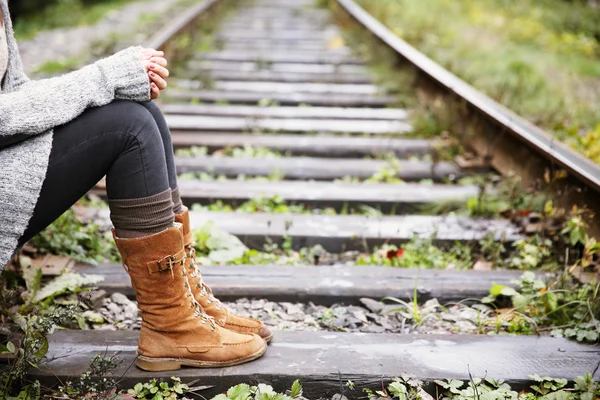 Woman sitting on rail track — Stock Photo, Image