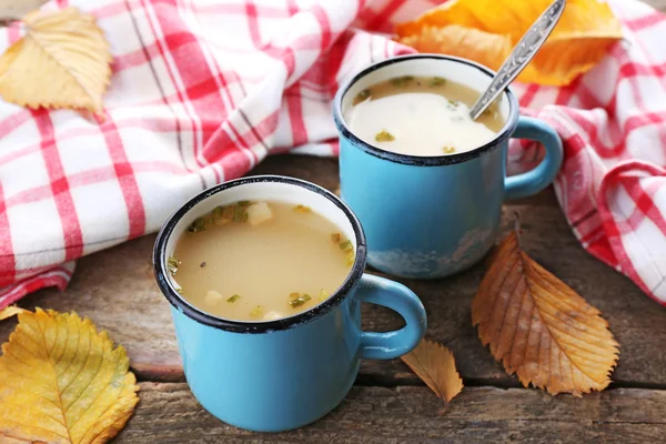 Two mugs of soup and napkin — Stock Photo, Image