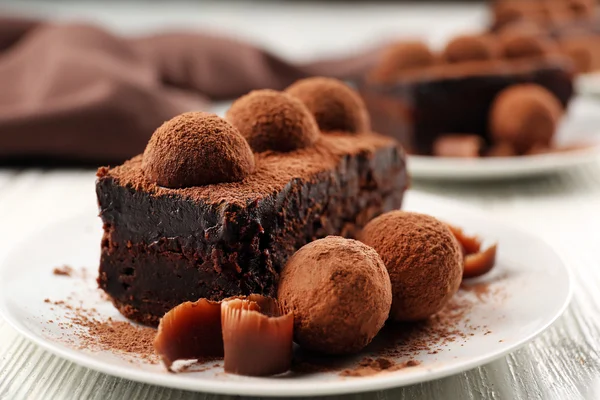 Slice of chocolate cake with a truffle — Stock Photo, Image