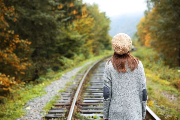 Woman walking on rail of railway tracks — Stock Photo, Image