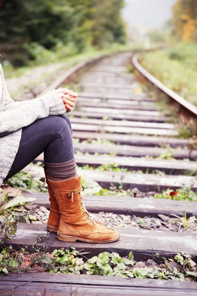 Woman sitting on rail track — Stock Photo, Image