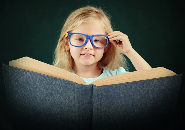 Vacker liten flicka med bok — Stockfoto