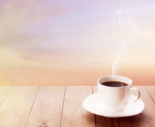 Cup of coffee on sky background