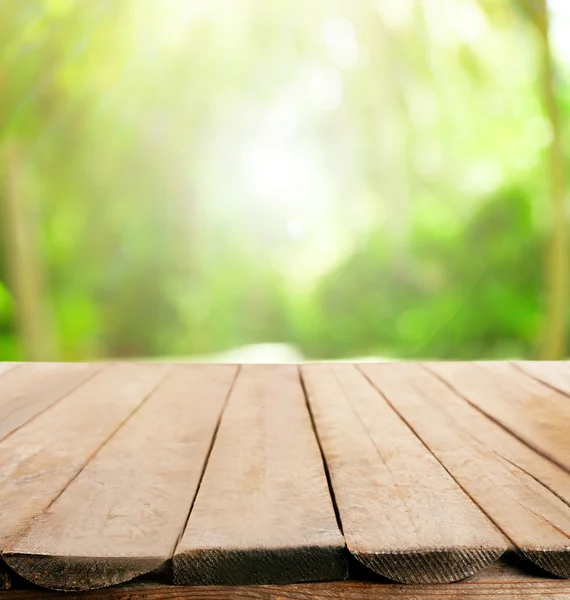 Wooden board on blurred nature background — Stock Photo, Image