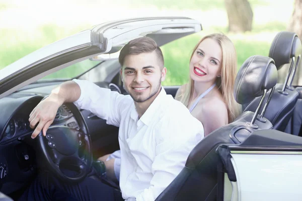 Parejas jóvenes en cabriolet, al aire libre — Foto de Stock